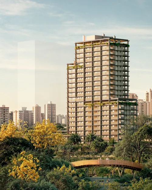 Riza visto do parque, com a ponte paisagística e ipês floridos em primeiro plano